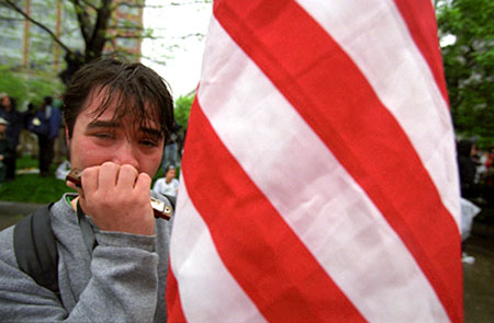 An anti-Globalization protester play harmonica after police used pepper spray on protesters during a meeting of the IMF and the World Bank in Washington, D.C. April 16, 2000