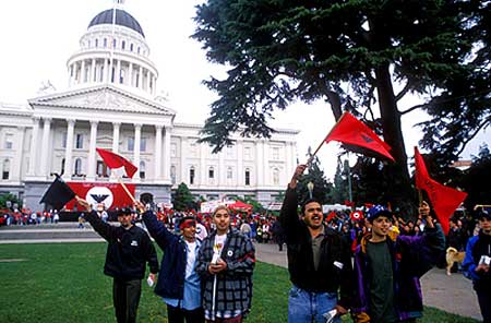 Latinos wave United Farm Worker flags outside the California capitol, where marchers were arriving after a 350-mile foot journey from Delano to Sacramento.